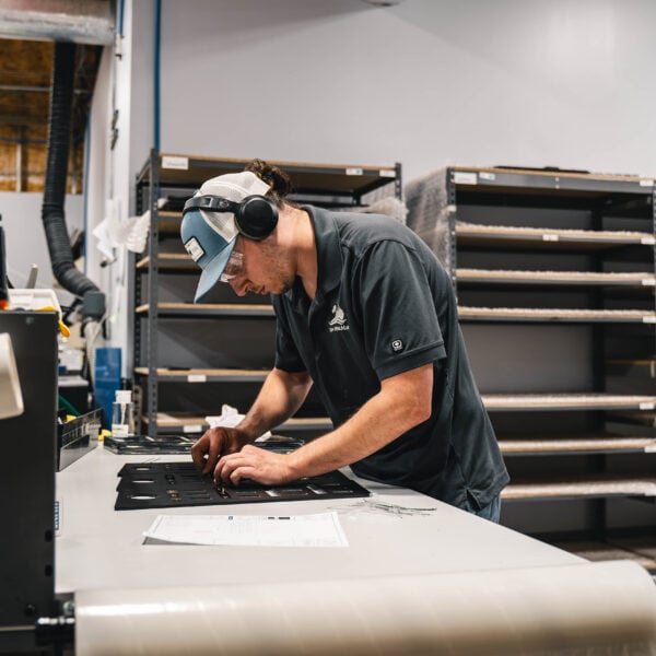 employee assembling boat storage parts