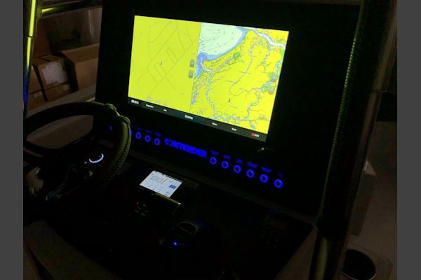 Illuminated switch panel on a Contender 24 Sport showing night-time visibility