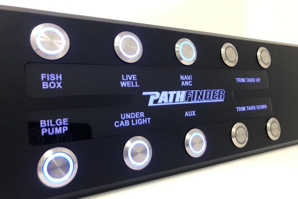 Close-up of Pathfinder dash panel featuring illuminated push button switches and clean black acrylic finish