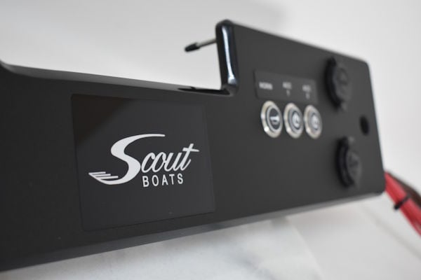 Close-up of custom Scout Boats switch panel with laser-etched labels and marine-grade pushbutton switches