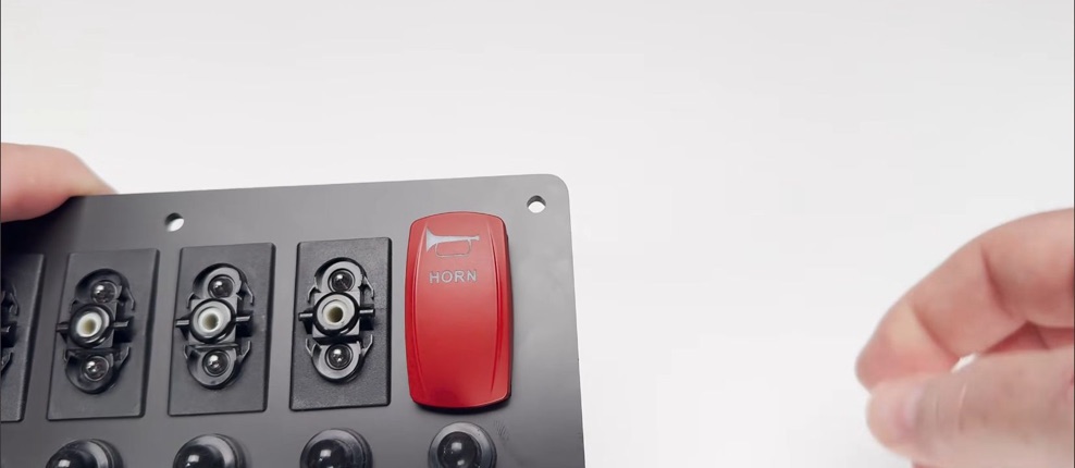 Red horn rocker installed in a SEAready boat switch panel