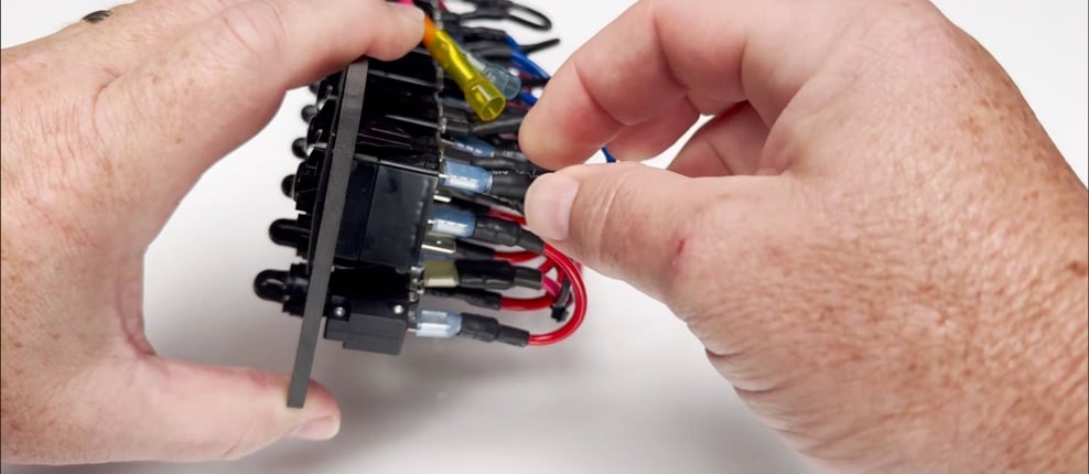 Removing an installed latching switch from the back of a SEAready boat switch panel