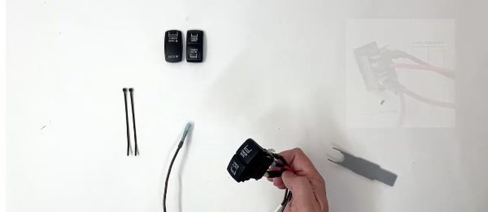 Timer Pod switch harness with the remaining lead held beside the switch