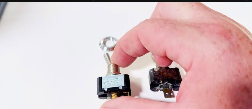 Comparing the old marine toggle switch with its replacement before installation