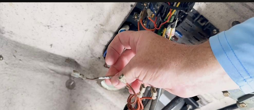 Labeled accessory wire connected to a terminal on the replacement marine toggle switch