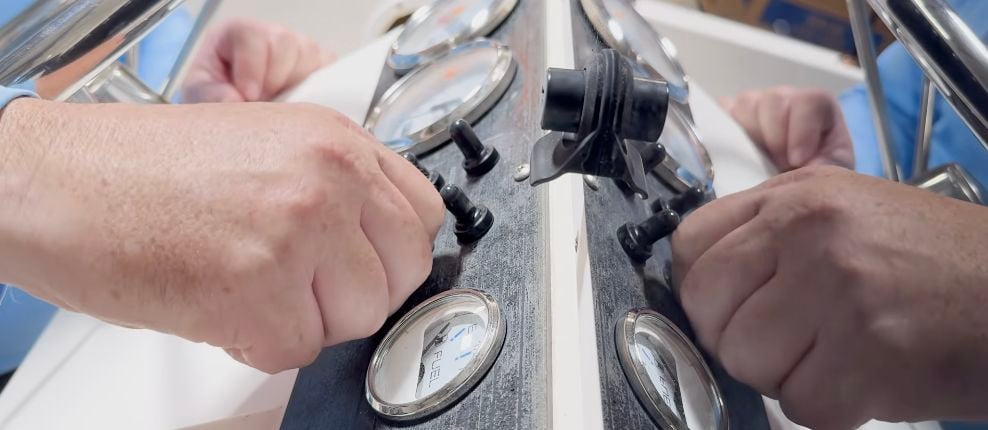 Removing the mounting nut and rubber boot from an existing marine toggle switch